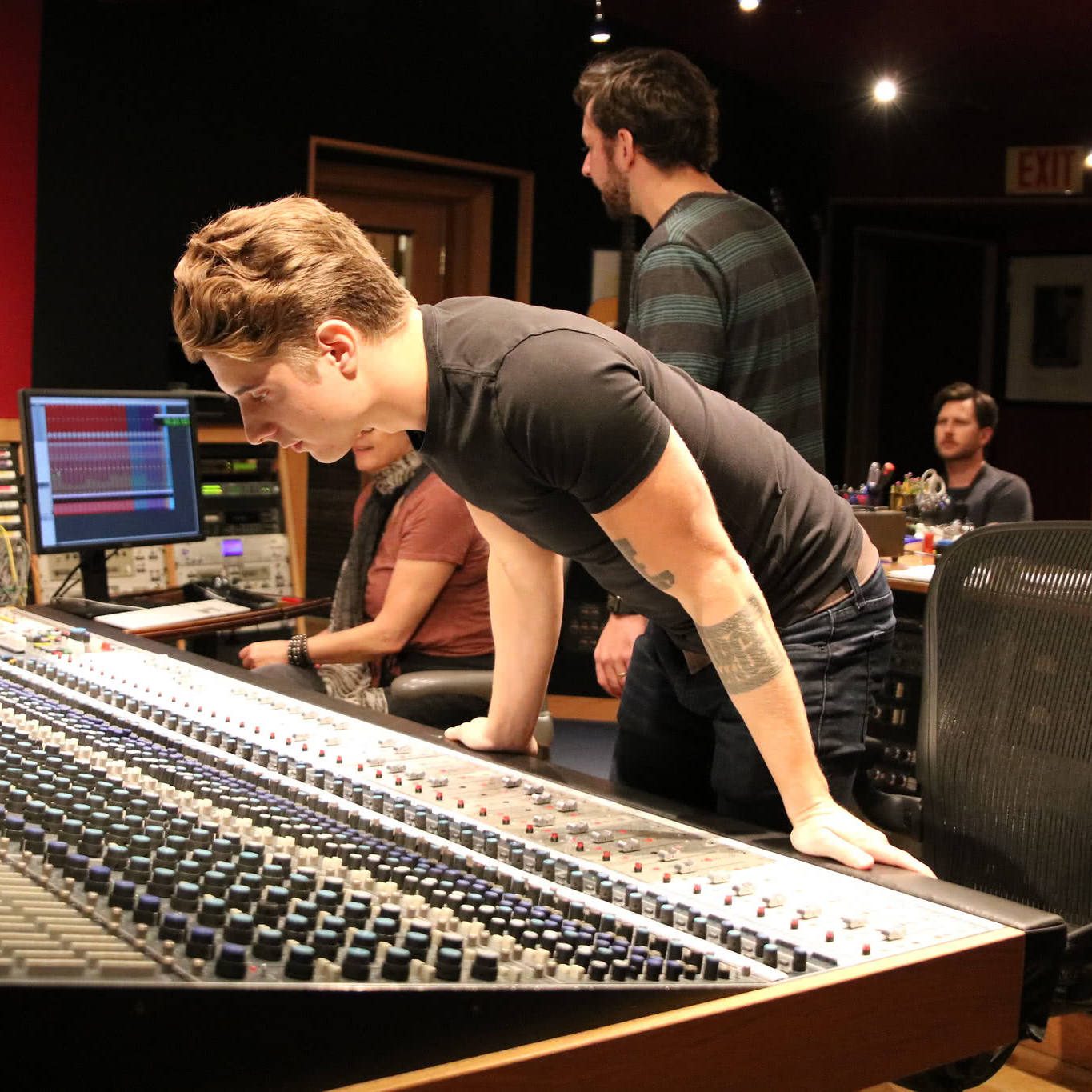 Student working at the Neve 8078 console in Studio A